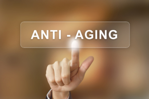 business hand clicking anti aging button on blurred background